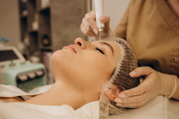 Woman get facial hydro microderm abrasion peeling treatment therapy. Cosmetic beauty Spa salon....