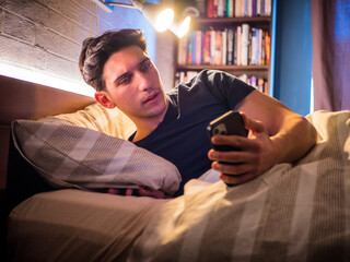 Man checking notification on smartphone at night