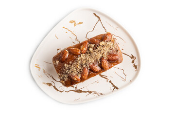 Caramel and almond cake isolated on white, top view.