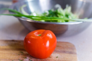 Tomato on salad cutting board