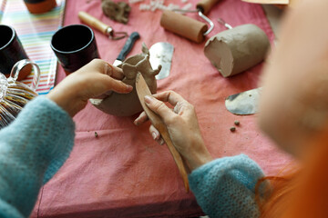 Pottery workshop class. A pottery crafts dish from a raw clay. Creating ceramics