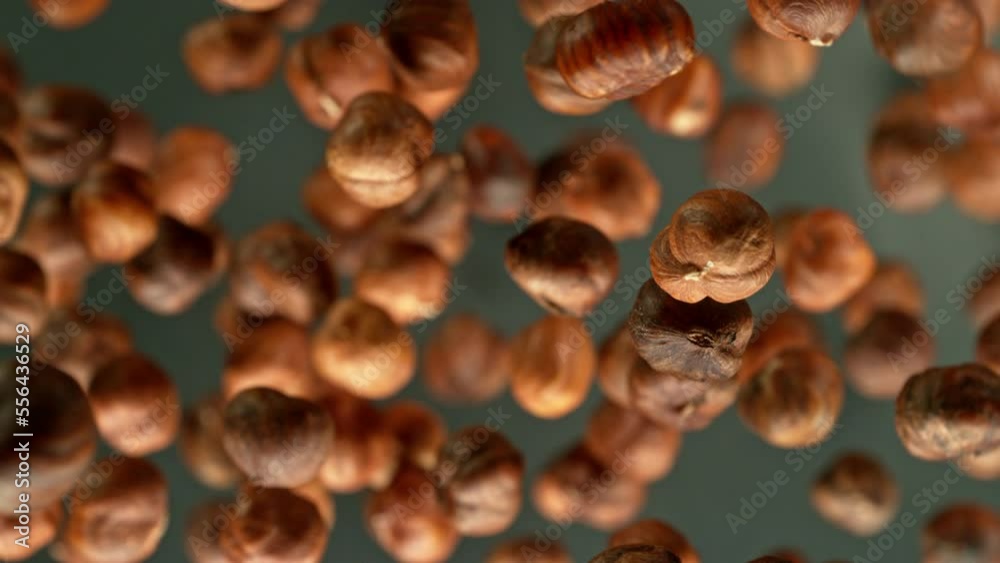 Poster super slow motion of rotating hazelnuts up to the air. filmed on high speed cinema camera, 1000fps, 