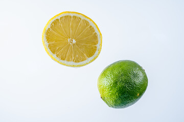 sliced lemon and green lime isolated white background