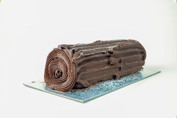 chocolate swiss roll log isolated on a white background with copy space