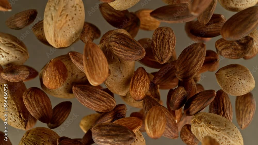 Poster super slow motion of rotating almonds up to the air. filmed on high speed cinema camera, 1000fps, pl