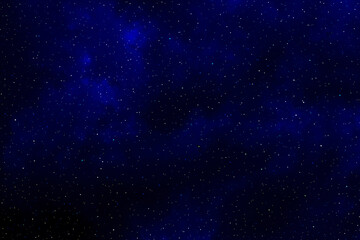 Starry night sky.  Galaxy space background.  Glowing stars in space.  Dark blue night sky with stars. 