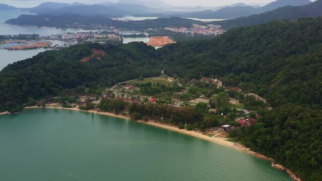 Aerial view drone flyover towards popular tourist spot Teluk Batik beach with marina island and damar laut in the background, straits of malacca, Lumut, Perak, Malaysia, Southeast Asia.