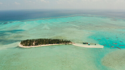 Tropical island among coral reefs with a white beach and blue atoll water. Onok Island, Balabac,...