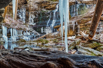 Beautiful winter icy waterfall with moss covered rocks and icicles hanging from the bluff. Machine Falls located at Short Springs Natural Area in Tullahoma, Tennessee USA.