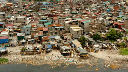 Slums in Manila near the port. River polluted with plastic and garbage. Manila, Philippines.