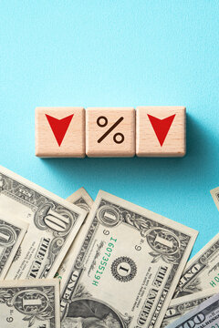 Wooden blocks with interest rate percent of bank with US dollars, financial world economy crisis design concept.