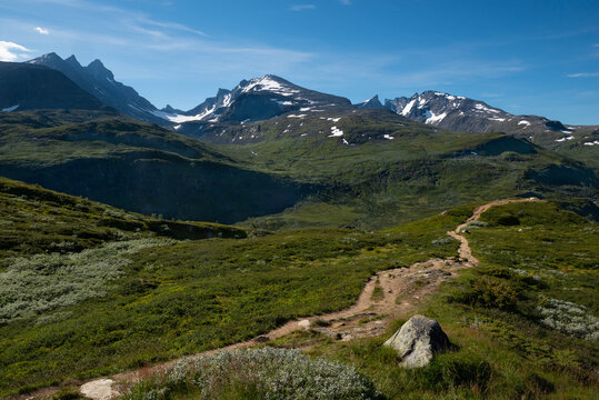 Scenic view on green valleys and mountain sides with snowy peaks along the scenic Sognefjellet road, Jotunheimen National Park, Norway