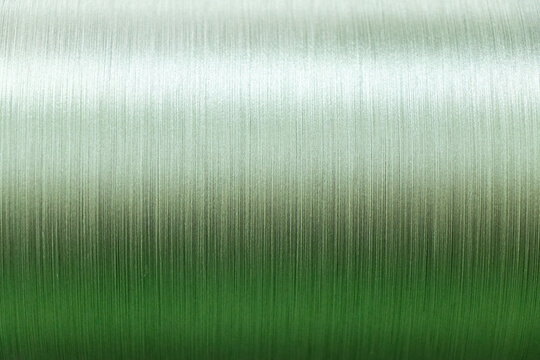 Closed up of green color of thread textured background (Focus at center of picture)