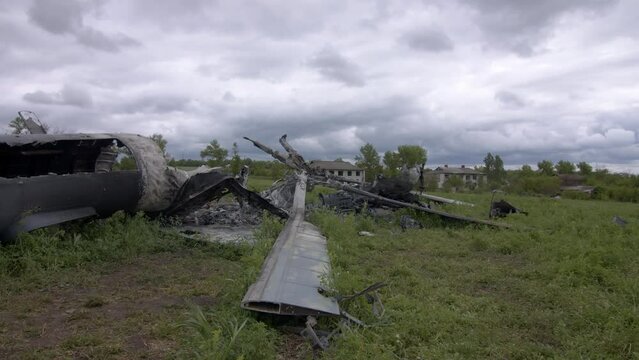 Crash site of destroyed and burnt russian aircraft shooted by Ukrainian air defense. Combat plane eliminated after bombing civilian homes in village near Kharkiv 25.05.2022