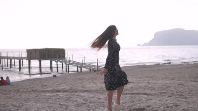 Beautiful brunette girl on the beach by the sea, Turkey, Alanya.