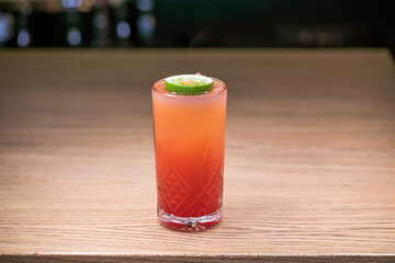 Alcoholic cocktail on wooden board