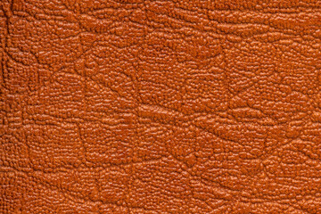 Brown artificial or synthetic leather background with neat texture and copy space