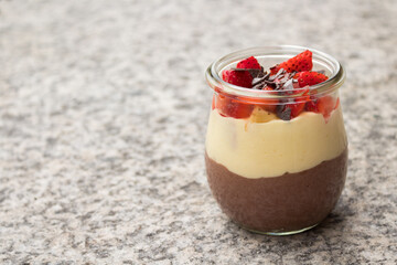 Delicious looking glass layer dessert isolated on a natural marble underground