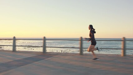 Running, cardio and woman at promenade during sunset, fitness journey and training for health by the sea in Indonesia. Sport, challenge and runner sprinting for performance and exercise by the ocean