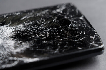 Black smashed crushed mobile phone with broken cracked display