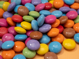 Small multi-colored round candies. Sweets covered with sugar icing.