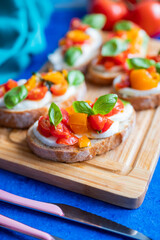 Fototapeta na wymiar crispy bruschetta bread with mozzarella cheese with tomatoes and basil