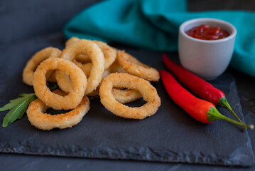 fast food breaded onion rings fried with french fries with sauce
