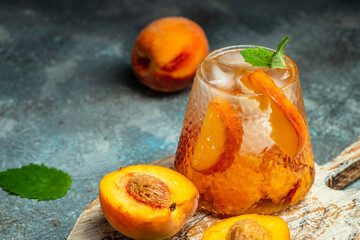iced peach cocktail with peach slices, summer Peach cocktail, homemade peach lemonade with ice...