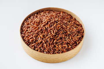 raw fresh red rice on a white background