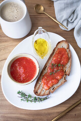 Healthy breakfast, bread with olive oil and tomato and coffee