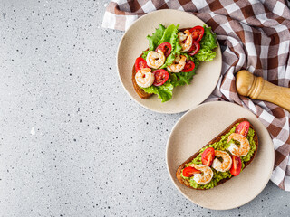 delicious Italian bruschetta with shrimps on a gray stone background