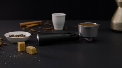 Portafilter on the black Table With Coffee Stuff