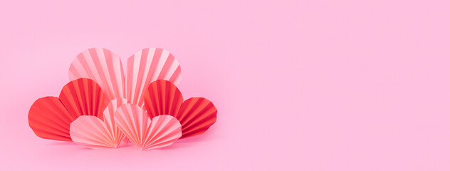 Banner with paper hearts on pink background. Still life minimalistic composition for Vlentines Day