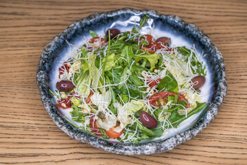 Restaurant dish meat salad on a blue plate