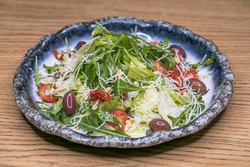 Restaurant dish meat salad on a blue plate