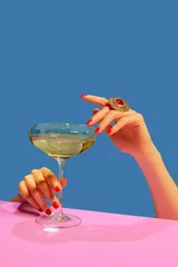 Foto op Plexiglas Female hands holding glass with champagne over blue pink background. Festive celebration. Food pop art © master1305