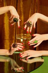 Female hands around glass with champagne over golden background. Luxury, festive aesthetics. Christmas party