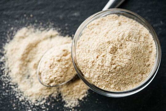 asafoetida aromatic powder on a black stone background