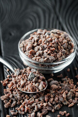 crystalline black Himalayan salt on a black wooden background