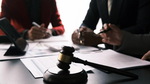 Teamwork of business lawyer meeting working hard about legal legislation in courtroom to help their customer.