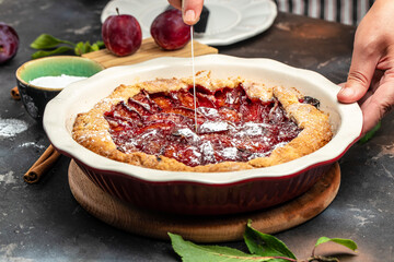 Plum Galette. Woman hands holds plum cake or pie. banner, menu, recipe place for text
