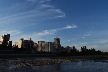 Sapporo Japan November 1, 2022 The cityscape of the central Sapporo city along with the Toyohira river with the clear blue sky 