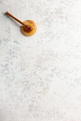 Natural honey spoon on empty concrete background with copy space