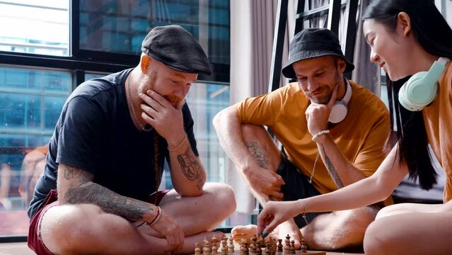 4K, A group of three tourists doing activities while waiting to hang out in tourist attraction, Man woman play chess together, woman was very reluctant to move chess piece, was determined to beat man.