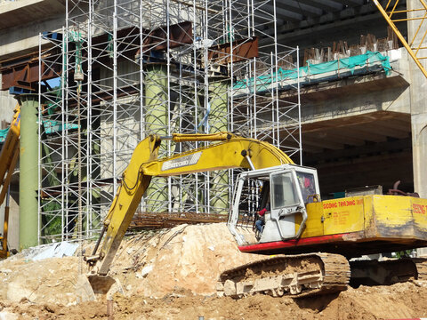 MELAKA, MALAYSIA -MARCH 6, 2021: Excavators machine at the construction site. It is used to excavate and lifting soil and other material at the construction site. Powered by the hydraulic arm with a b