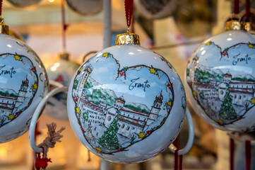 Christmas decorations at the traditional Christmas - Christmas market souvenir, markets of Trento city - northern Italy. Selective focus with shallow depth of field