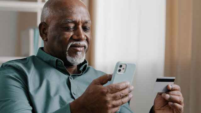 African old bald bearded senior elderly businessman upset angry retired man has money problem online transfer payment error blocked bank account trouble with e-payment with phone app and credit card