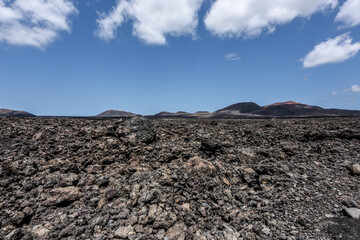 Bizarre volcanic landscape of Timanfaya National Park with black lava fields, Lanzarote, Canary Islands