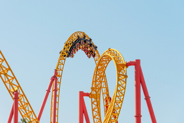 Roller coaster up down turn and a passing loop feint, spiral train of trolleys tends to go down.