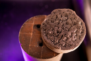 Used, destroyed, with deformation. Filter of harmful emissions, catalyst from the vehicle. detail close up view. Material containing precious metals. Muffler of the exhaust system.